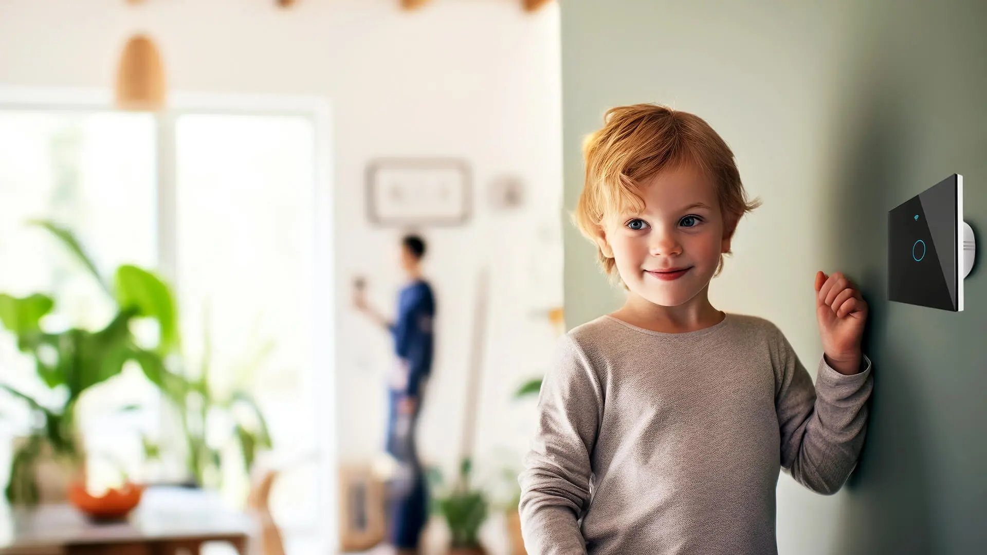 A young boy standing in front of a window.