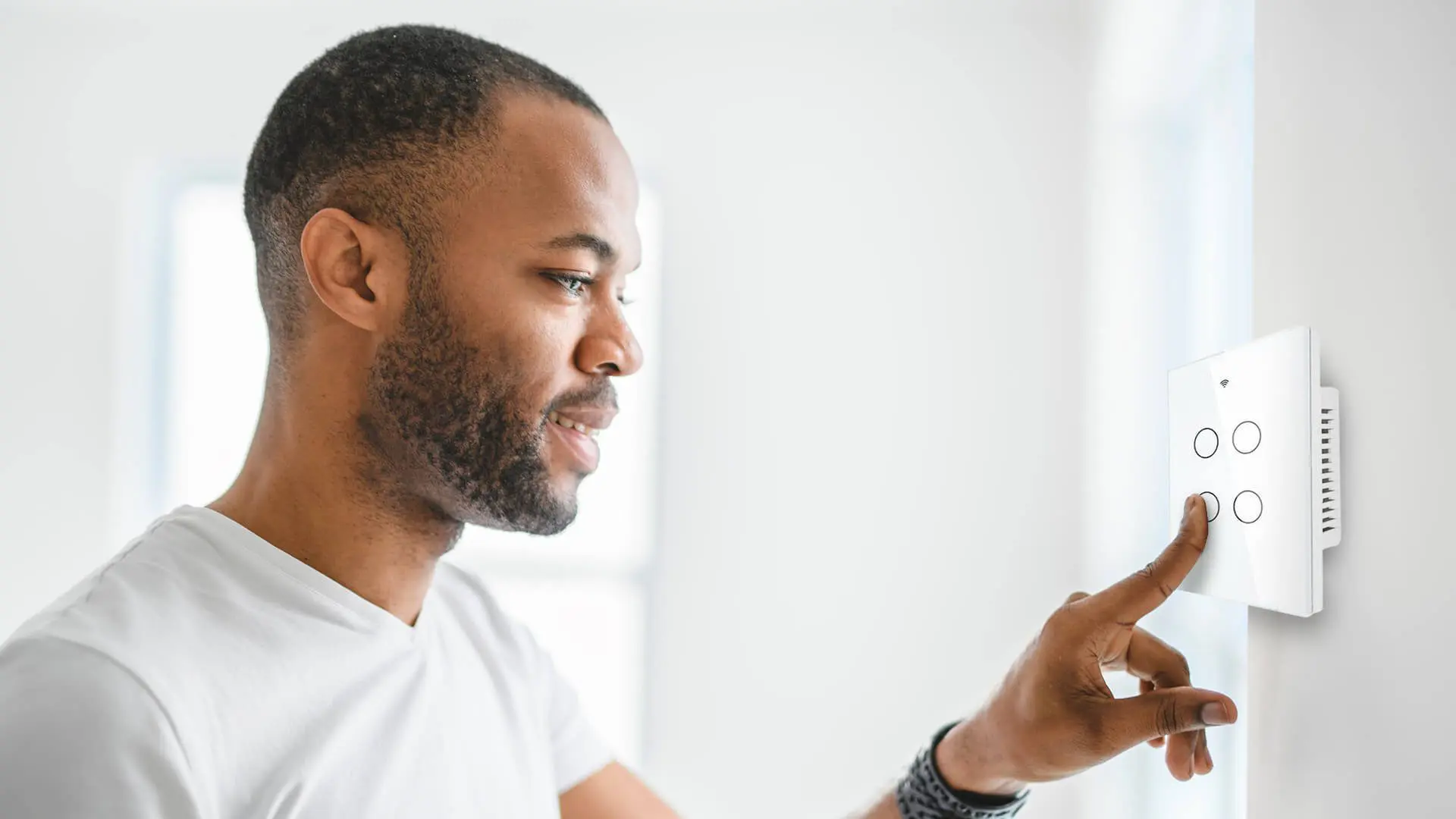 A man looking at his phone while wearing white.